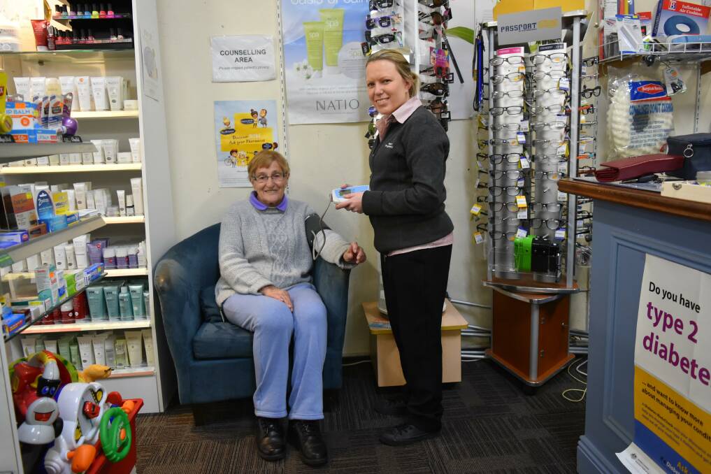 FRIENDLY PRECAUTIONS: Mavis Buckley, of Henty, catches up with Samara Donohue, of the Henty Pharmacy. Picture: Lorri Roden 