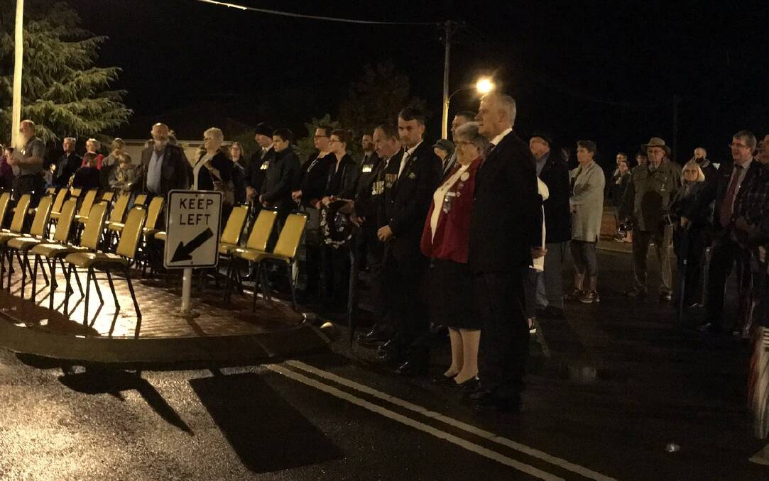 SHOW OF RESPECT: Members of The Rock community brave the wet conditions to participate in the dawn service. 