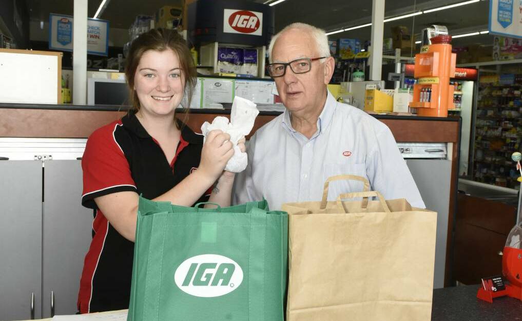 Jindera supermarket employee Amy Hanel with store owner Bob Mathews. 