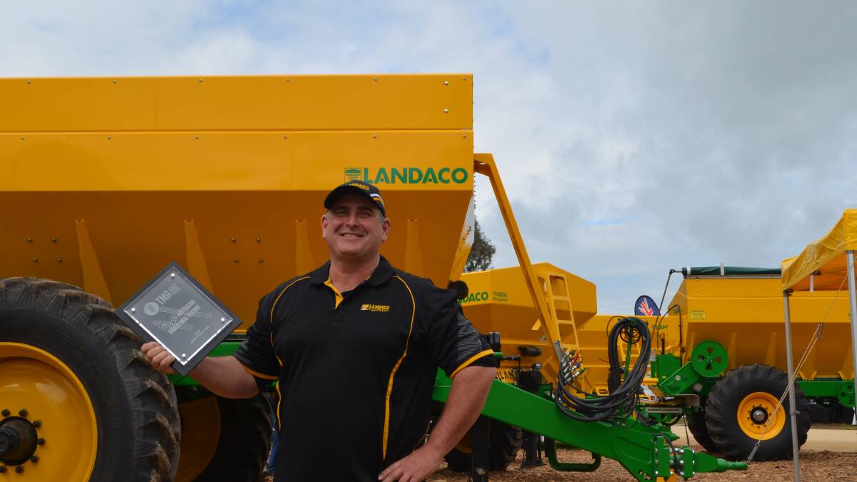 Principal of Landaco, Wagga, Peter Connor accepts the Tractor and Machinery Assocation machine of the year award at Henty Machinery Field Days. 