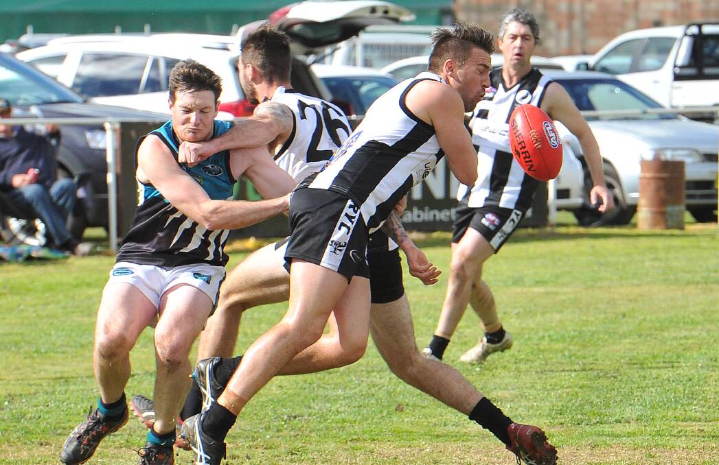 CHIN UP: Northern Jets defender Mitch Robinson is brought to a halt by TRYC's Josh Ashcroft as he attempts to stop Magpie Mitch Ward at Gumly on Saturday.
