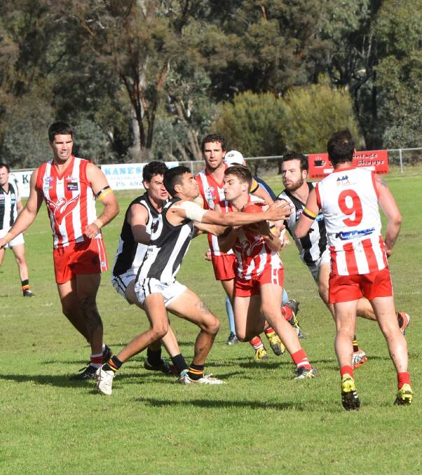 TOUGH DAY: Murray Magpies' Ben Clements clashes with Henty's Andrew Yates. Henty lost the weekend match by 53 points. Picture: Lorri Roden
