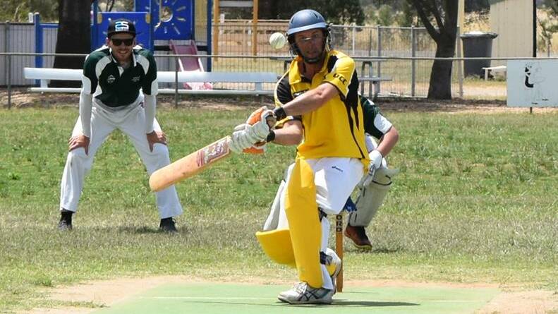 SWING: Osborne's Darren Howard takes a swing while Holbrook's Jimmy Grills watches on during the weekend HDCA clash. Picture: Lorri Roden