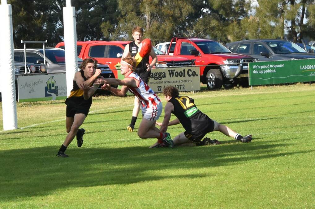 STRONG FORM: Izaac McDonnell, Osborne, and Anthony Pope, Henty, face off during the Hume Football League clash at Osborne on the weekend. Picture: Lorri Roden