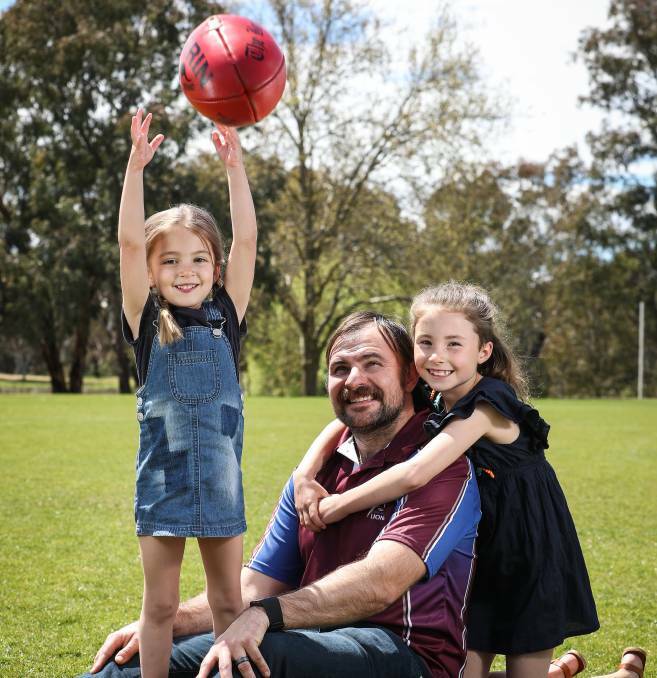 HAVING A BALL: New Culcairn coach Josh Hillary with his daughters Lola and Evie. Picture: Border Mail