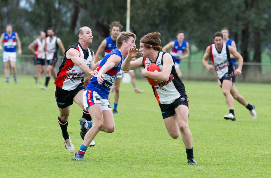 CLASH: Brocklesby-Burrumbuttock youngster Josh Koschitzke attempts to break a tackle against Jindera on Saturday. The Bulldogs won by 19 points.