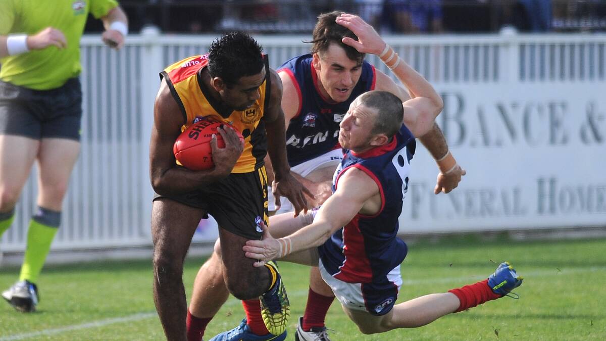 CHASE IT: Hume Football League's John-Roy Williams is chased down by Riverina Football League's John Bucanan and Chase Grintell at Robertson Oval for the representative match at the weekend. Picture: Laura Hardwick