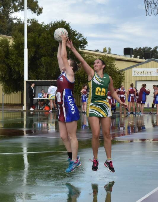 TOP SHOTS: Emily Pinnuck shoots for Culcairn, while Holbrook's Lauren Ryan defends during the Hume League netball at the weekend. Picture: Lorri Roden