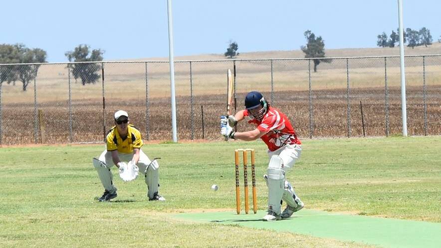 COUNTRY CRICKET: Daniel Hore-Smith aims to connect for Henty as Osborne wicket-keeper Luke Richardson watches on. Picture: Lorri Roden