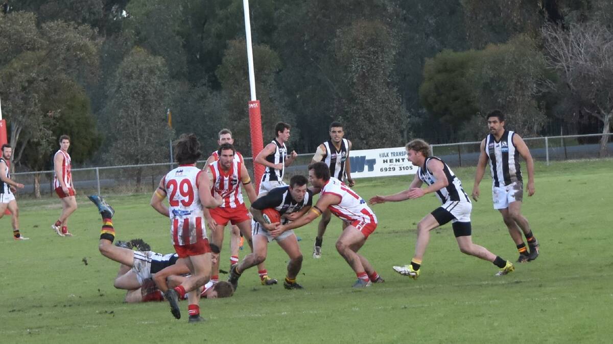 CLASH: Josh Maher, Murray Magpies, and Damian Maloney, Henty. Picture: Lorri Roden
