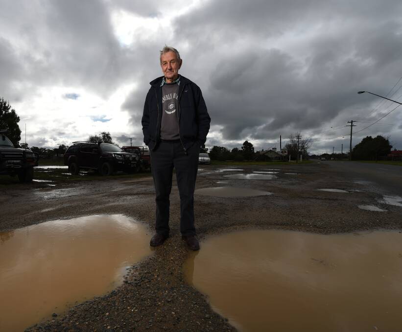 FED UP: Walla resident Keith Churches is sick of the state of roads and pathways in the town's main street. His exasperation with potholes comes after years of inaction with a dangerous piece of footpath. Picture: MARK JESSER