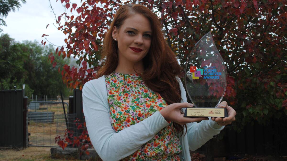 Sarah Verdon proudly displaying her award at her parents home in The Rock. Picture: Lorri Roden.