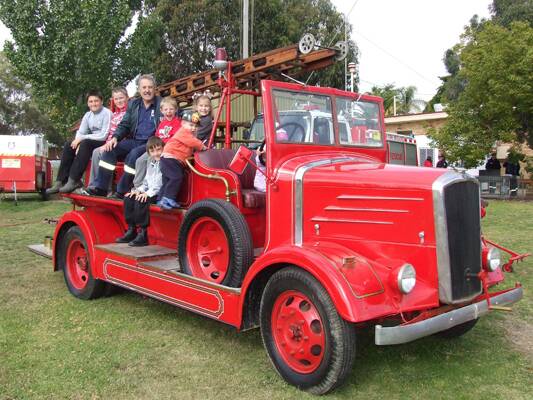 Having fun at the Henty fire station open day on Sunday were back row left to right:  Jedd Lieschke, David Damschke, Joe Wilson (NSW Fire Brigade), Kobie Skeers, and Elsa Meyer. Front row Shaun Ripps and Fergus Meyer (wearing his fire chief’s helmet). Photo: Phil Takle