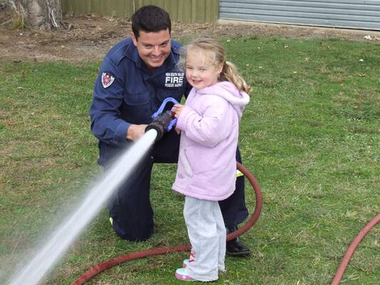 NSW Firefighter Dave Weston with Eliza Murphy .