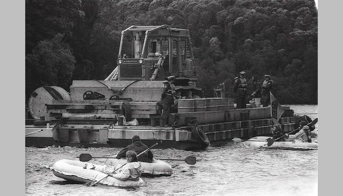 Protesters in small inflatable boats on the Franklin River, facing a bulldozer, 1982. Photo: John Krutop