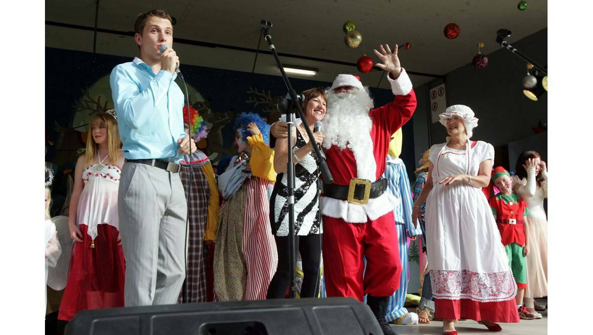 Jake Speer and Barb Wright with Santa on stage at Light Up Leeton. Picture: The Irrigator