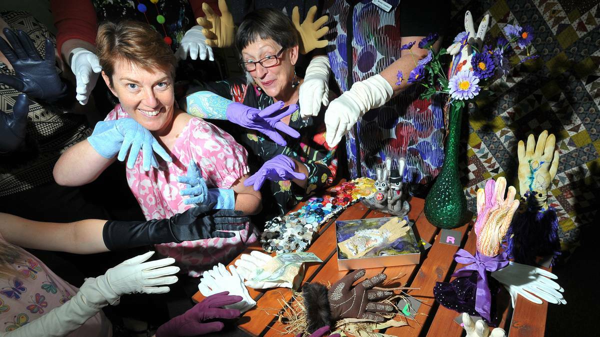 Penny Wright and Di Richardson are surrounded by beautifully decorated gloves at the Wagga Group of the Embroiderers' Guild's exhibition titled Signatures. Picture: Riverina Leader