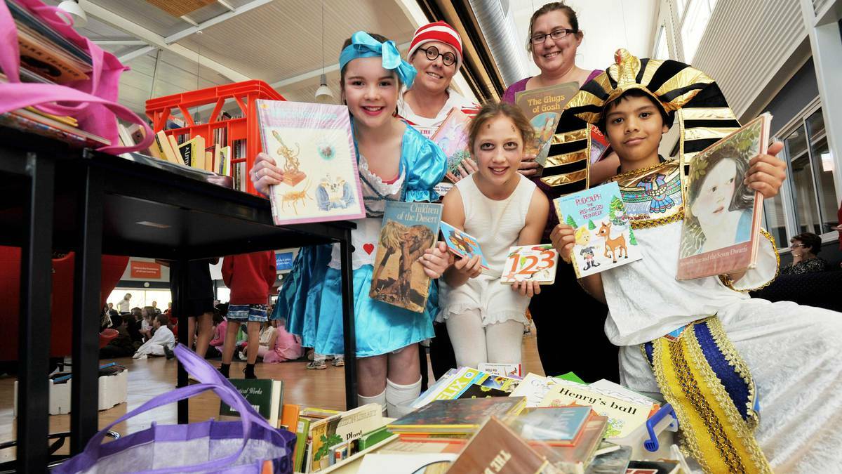 Sacred Heart Primary School pupils Mia Smith, Lucy Anderson and Nick Pallai, librarian Sarah Pembleton and Angels for the Forgotten coordinator Melina Skidmore look over a pile of books donated by the school community. Picture: Riverina Leader