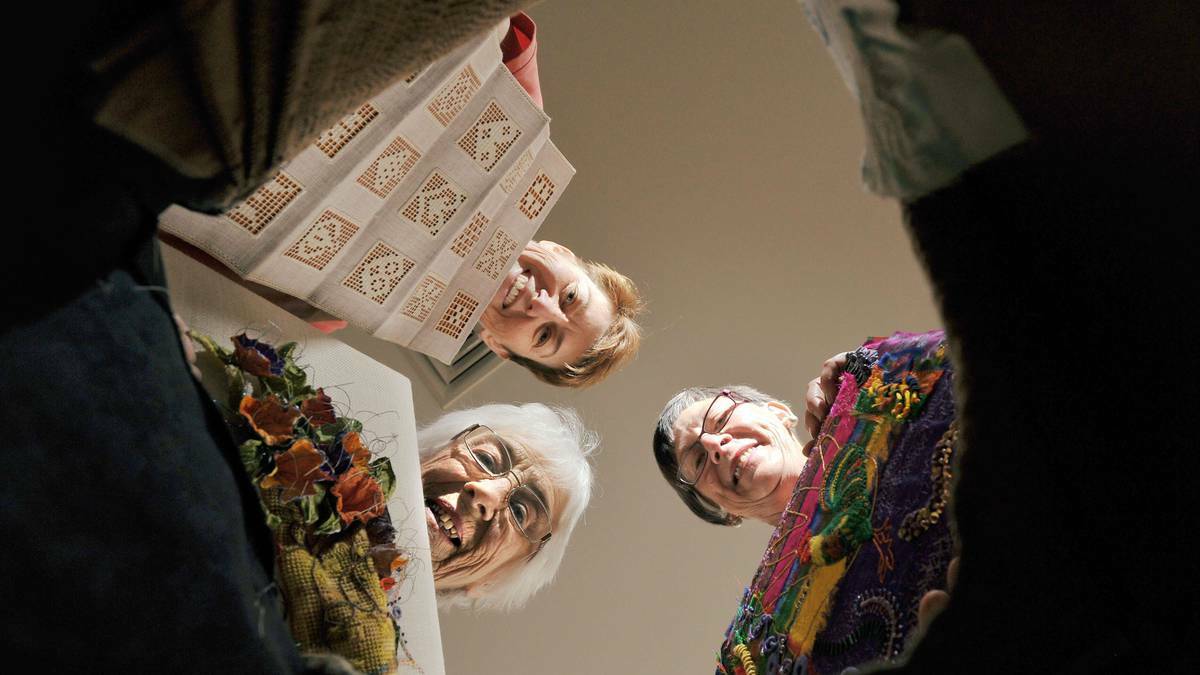 Clockwise from top left) Penny Wright, Di Richardson and Fay Grant file through boxes of embroidery in the lead up to the Wagga Group of the Embroiderers Guild's exhibition. Picture: Riverina Leader