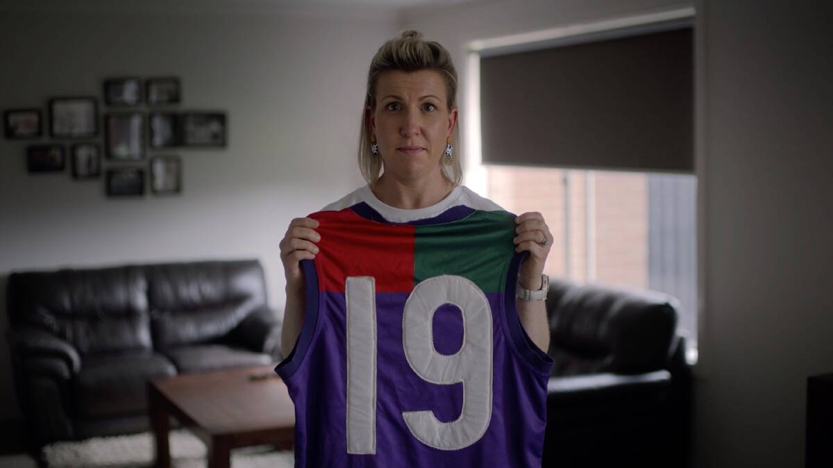 LEFT BEHIND: Josie Postlethwaite with her late brother's old football jumper that has been included in a new TAC campaign. Picture: supplied