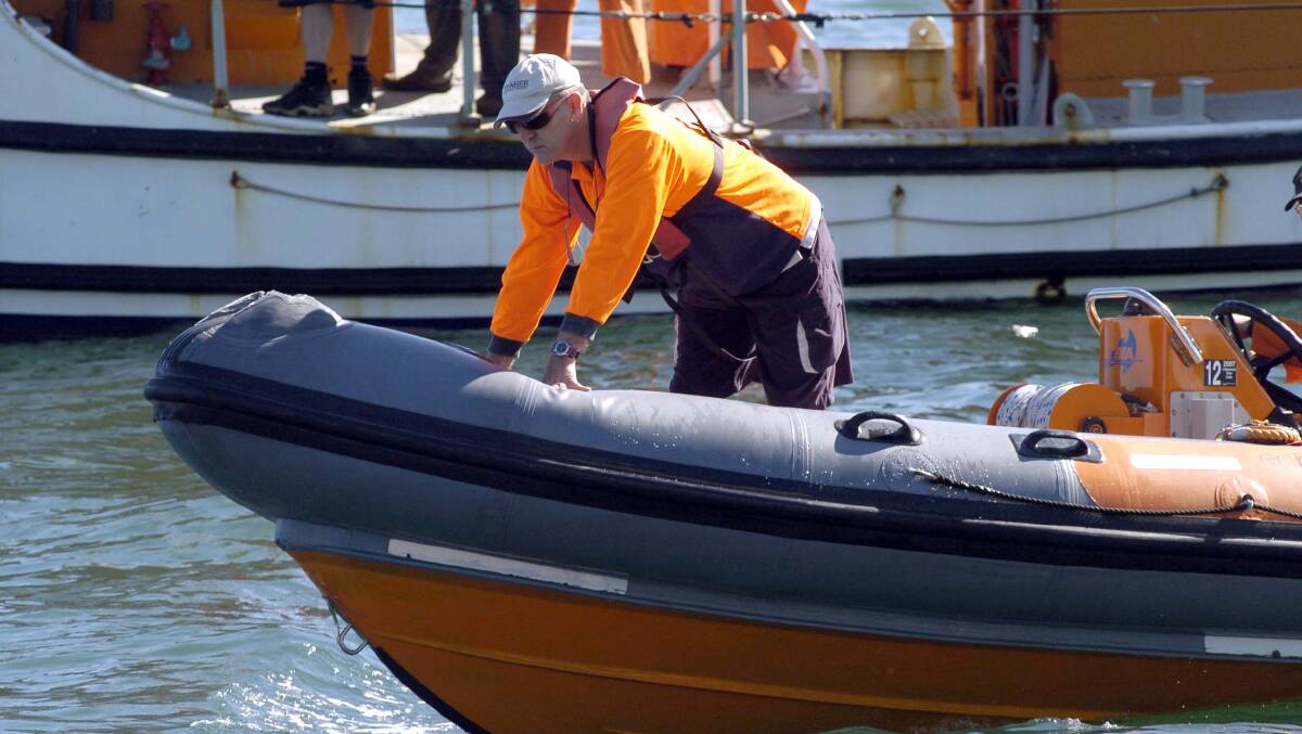 A NSW maritime rescue worker searches Sydney waterways. Picture Adam McLean