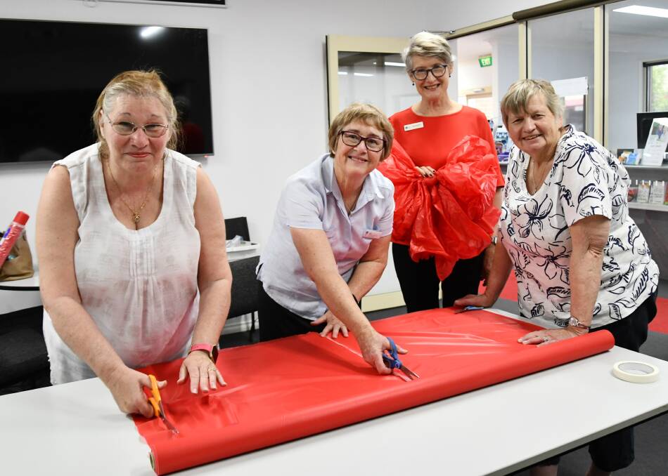 FESTIVE SPIRIT: Nina Shiels, Julie Colley Margaret Killalea and Jenny Stein cut and tie 30 bows to hang up throughout the Greater Hume. Picture Lorri Roden