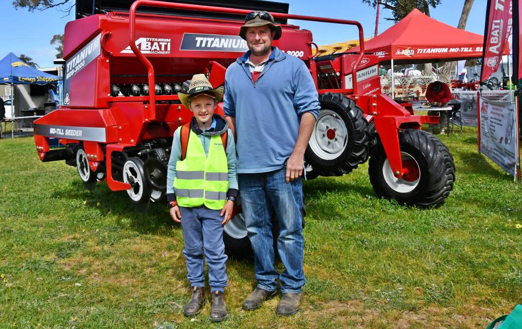 ENTHUSIASM FOR EXHIBITS: Dale Lieschke and son Aaron, 9, of Alma Park are pictured at Henty Machinery Field Days. Pictures: Lorri Roden