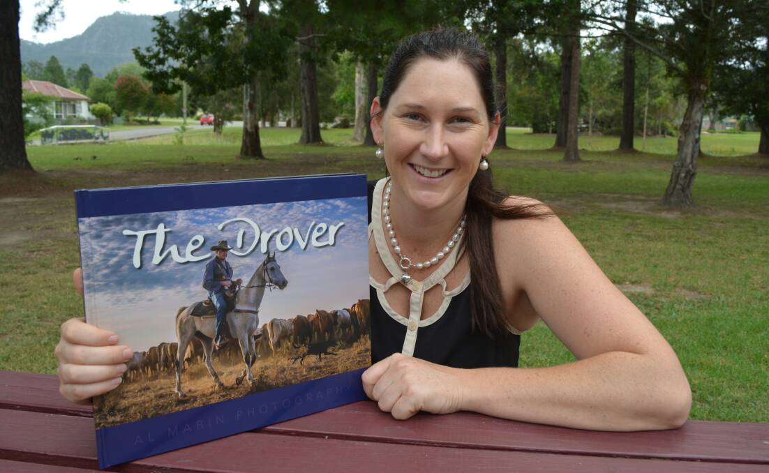 PICTORIAL DISPLAY: Author and photographer Al Mabin with her book The Drover. 