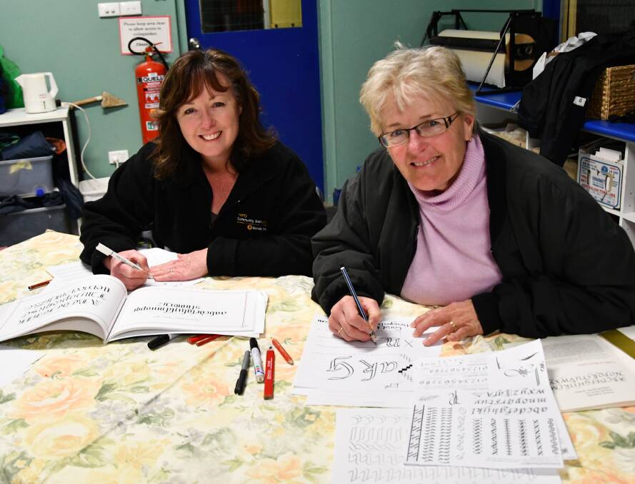 STROKE OF A PEN: Jacinda Singe and Stephanie Hanckle learning the art of calligraphy in the eastern Riverina. Picture: Lorri Roden 