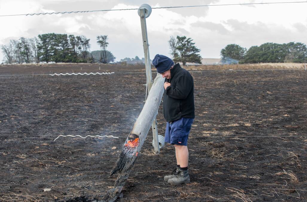 Charges: The Sisters farmer Jack Kenna with the snapped power pole which caused The Sisters/Garvoc fire. Picture: Christine Ansorge