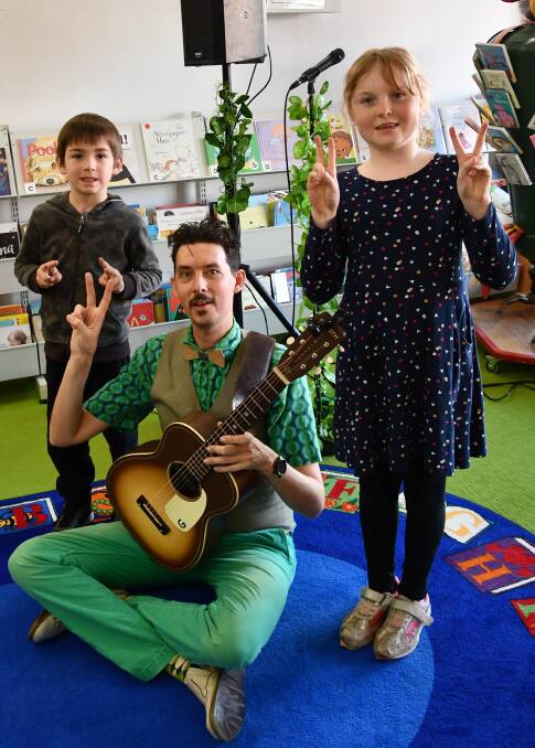 Declan Moore and Amber Barker with Aspara Gus from The Vegetable Plot, who entertained children at the Henty Library last week.