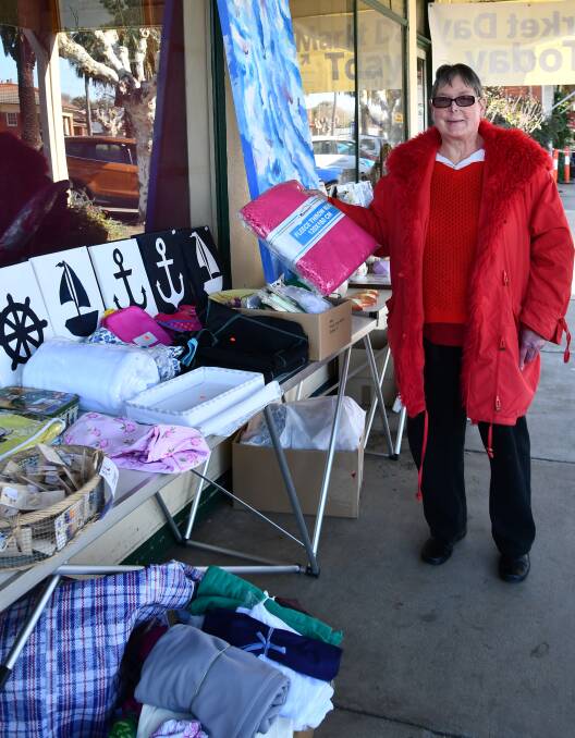 Secretary of the Culcairn Red Cross Craft Shop Bev Hoffmann with some of the items being reduced on their sale day
