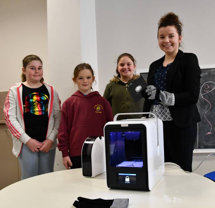 Madi Phillips, 11, Ellen Booth, 10, Zara Honeywill, 9, with Emily Jones at the 3D printing demonstration held at Culcairn Library.