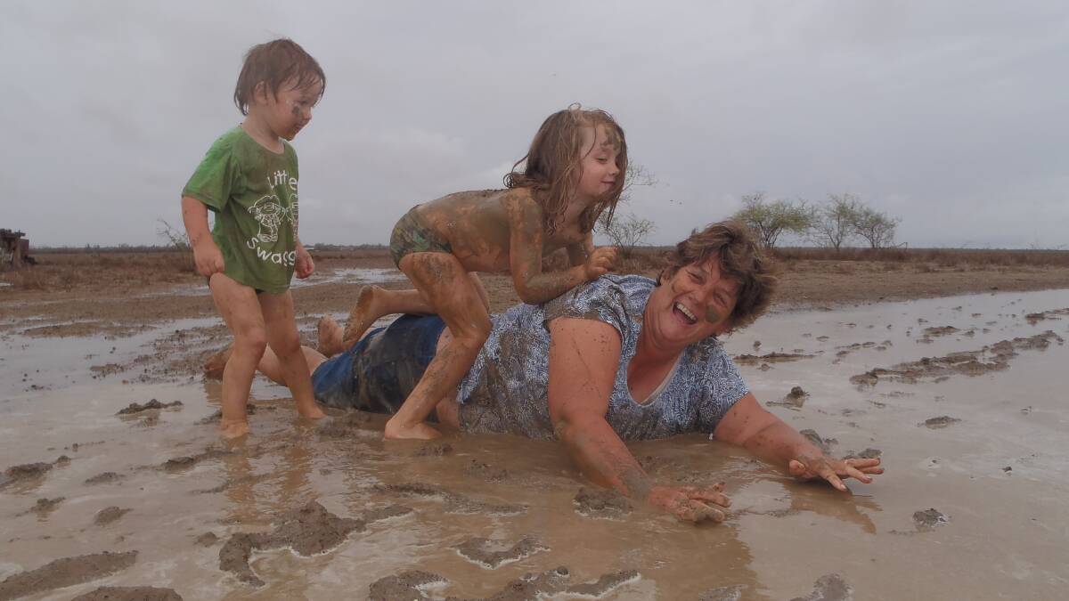 One of the page's founders, Winton grazier Donna Paynter enjoyed a 44mm downpour with her grandchildren Amber and Logan Ellis in January 2016. Picture - Heidi Paynter.