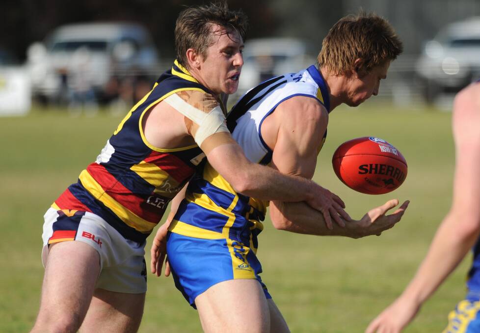 RULED OUT: Mangoplah-Cookardinia United-Eastlakes ruckman Nathan Byrne, pictured getting tackled by James Nancarrow on Saturday, has withdrawn from the Riverina League representative squad.