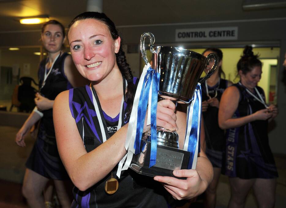 Jemima Norbury with the 2016 Wagga Netball Association A grade trophy. 