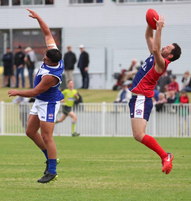 ON TOP: Riverina League full-forward Marc Geppert takes a mark over
Farrer League's Ned Mortimer on Saturday. Picture: Les Smith