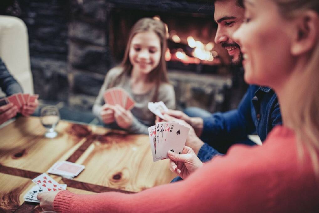 THE FAMILY THAT PLAYS TOGETHER: Card games are loads of fun. Photo: Shutterstock. 
