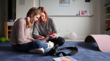 HER VOICE: Melanie Stephens with her daughter Ella, 11, who relies on a talker device to communicate with her family. Pictures: JAMES WILTSHIRE