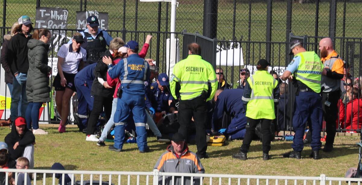 Paramedics attend to a spectator after a heart attack causing a delay to the A Grade netball grand final.