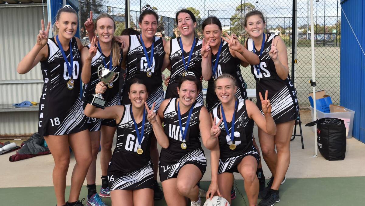 Sarah O'Leary, back left, celebrates with two medals and her teammates after being named best on court in TRYC's Farrer League grand final victory last month. Picture: Jacob Manley