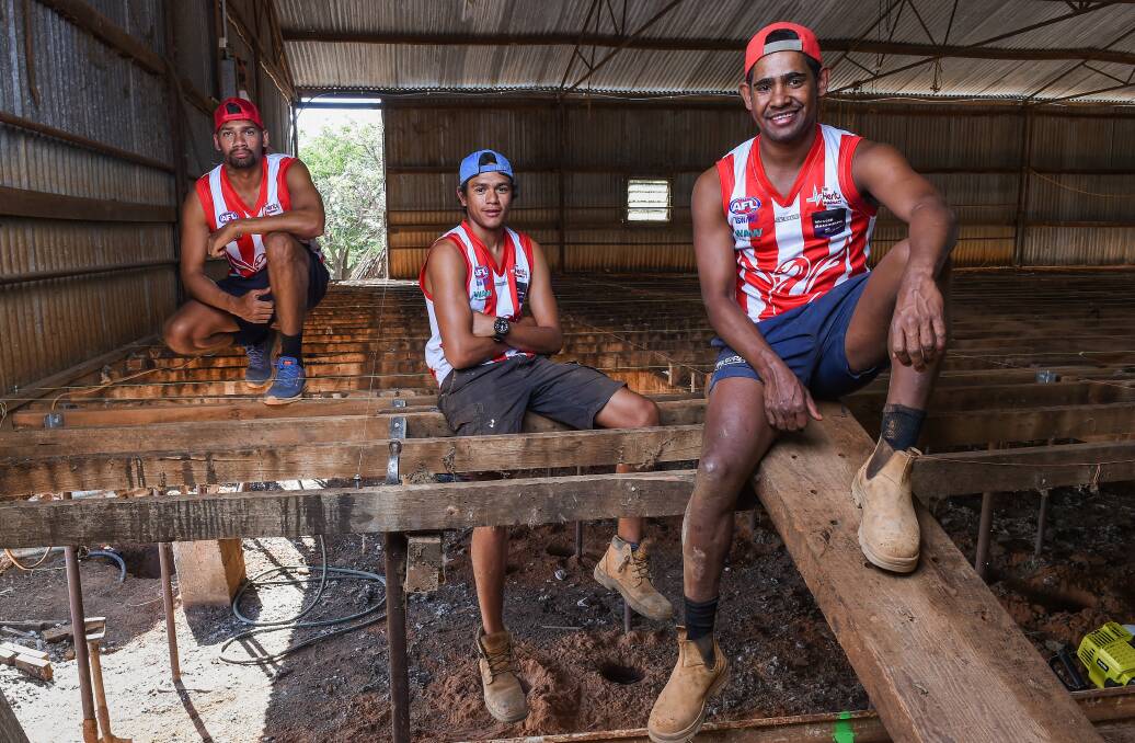 NEW EXPERIENCE: William Farrer and Dale and Daniel Cox take a break from rebuilding a woolshed near Henty. Picture: MARK JESSER