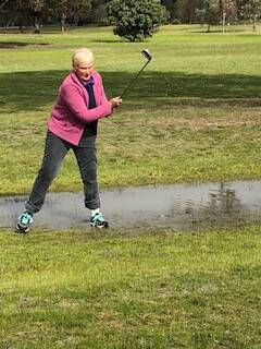 WET DAY: Kathy Maloney found a lot of water on the course last week.