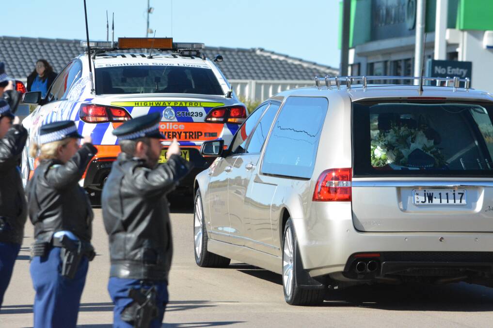 Goodbye: Police formed a line to salute Mick Horne as his hearse left the Bega civic centre following his funeral on Saturday. Pictures: BEGA DISTRICT NEWS