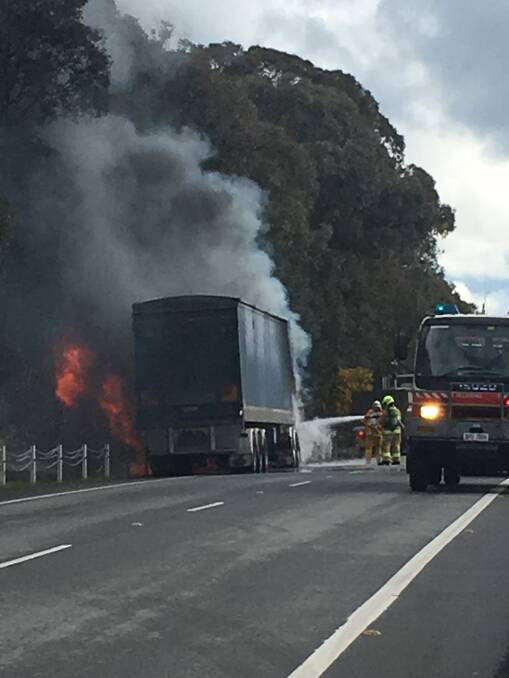 Fire fight: Hoses were drilled at unladen truck which caught ablaze on the Hume Highway north of Holbrook on Wednesday afternoon.
