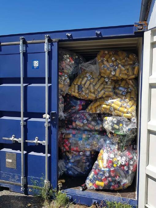 Full load: Cans piled high in a shipping container stored at the Henty IGA supermarket.
