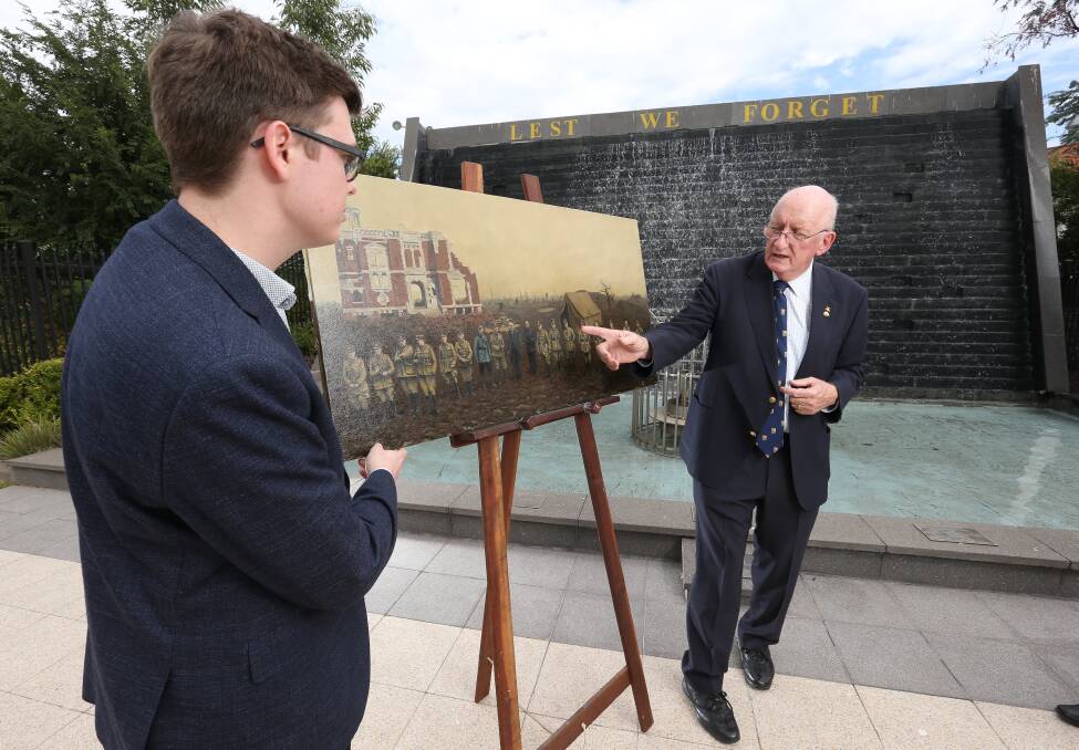 Delighted with his commission: Artist Kieren Marcombe looks on as Tim Fischer points to a detail of his work featuring generals meeting in the last months of World War I. Pictures: KYLIE ESLER