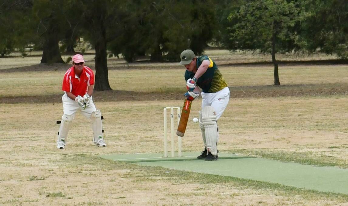 BIG DAY: Holbrook batsman Daniel McCarthy looks to play a shot as Henty wicketkeeper Stephen Zweck watches on during Saturday's clash. The Brookers' win came as they celebrated the club's 150th anniversary. Picture: Lorri Roden
