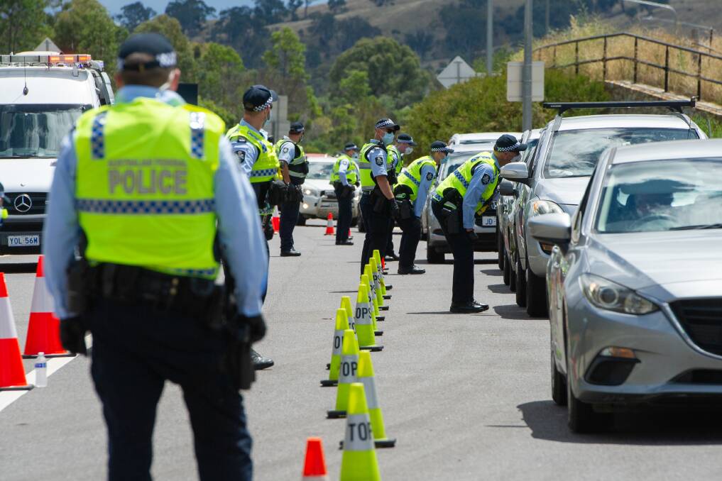 Police stationed on the ACT/NSW border helping enforce current public health orders. Picture: Elesa Kurtz