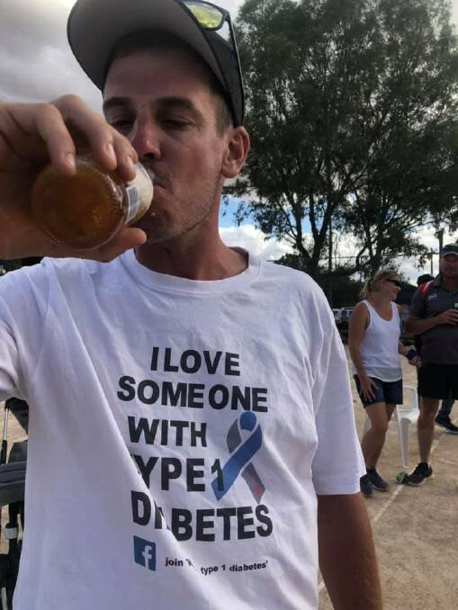 HARD-EARNED THIRST: Hill treats himself to a well-deserved beverage after completing his 24-hour tennis fundraising out in Uranquinty Tennis Club.